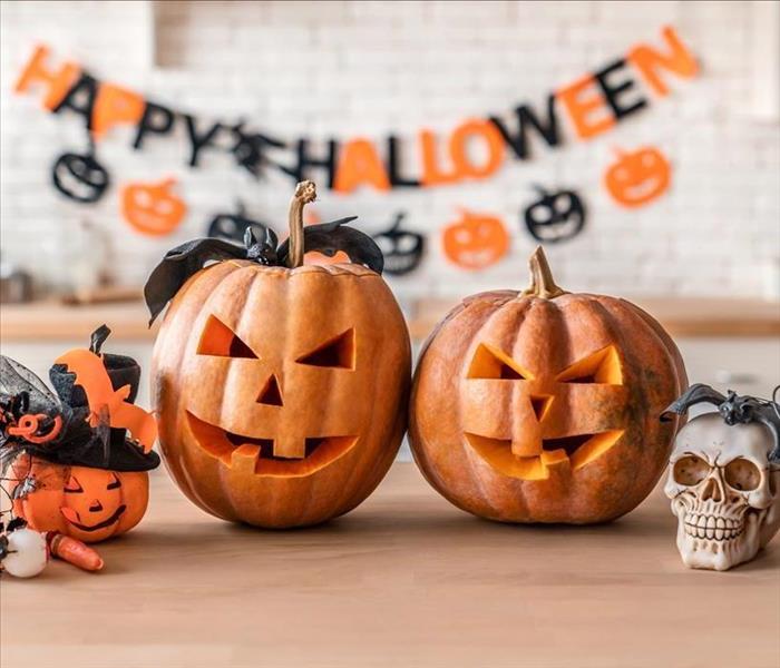 Halloween decorations, there is carved pumpkins, skulls, and other Halloween decorations. 